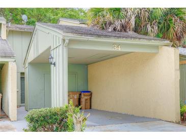 Covered carport with space for one vehicle and extra storage at 34 Saint Andrews Ct, Kissimmee, FL 34759