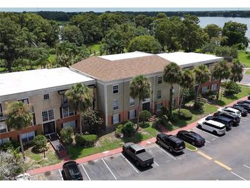 Aerial view of a condo building with parking and lake access at 4100 Dijon Dr # 4100E, Orlando, FL 32808