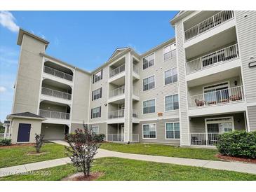 Three-story building exterior with landscaped grounds at 3174 Feltrim Pl # 104, Kissimmee, FL 34747