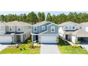 Community of two-story houses with gray and white exteriors at 4458 Kaipo Rd, Davenport, FL 33897