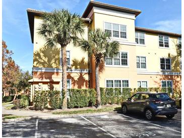 Tan building exterior with palm trees and parking at 5467 Vineland Rd # 6308, Orlando, FL 32811
