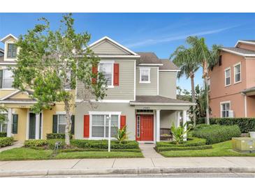 Two-story townhome with red shutters and a front porch at 1383 Alston Bay Blvd, Apopka, FL 32703