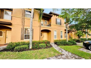 Townhouse exterior with walkway and landscaping at 2214 Calabria Ave, Davenport, FL 33897