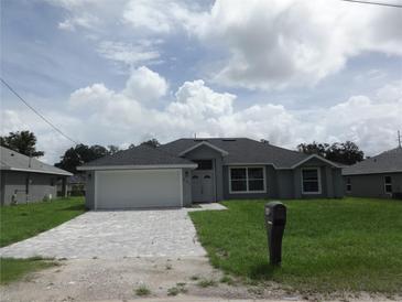 Single-story home with a grey exterior and a paved driveway at 541 Rhodes Dr, Deland, FL 32720