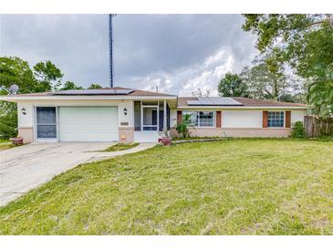 House exterior with solar panels and a spacious yard at 1522 Gainesville Dr, Deltona, FL 32725