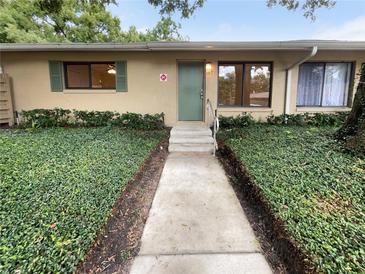 Condo exterior with walkway and lush landscaping at 220 Cherokee Ct # 107, Altamonte Springs, FL 32701