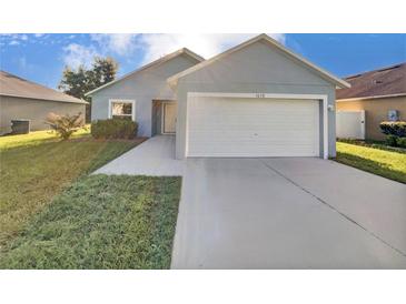 Single-story home with a two-car garage and driveway at 1078 Osprey Cove Cir, Groveland, FL 34736