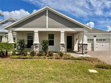 Two-story home with stone accents and landscaping at 5013 Center Ct, St Cloud, FL 34772