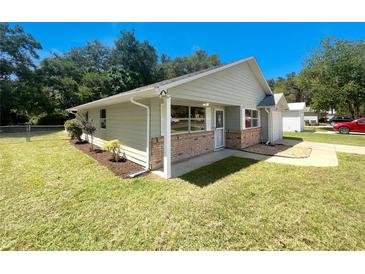 Charming one-story home with brick facade and landscaped yard at 213 Deborah Ave, Leesburg, FL 34748