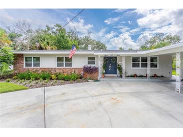 Ranch-style home with brick accents and landscaped yard at 905 Marabon Ave, Orlando, FL 32806