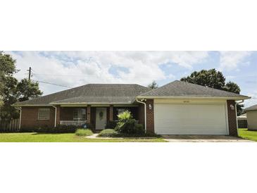 Brick house with a two-car garage and nice landscaping at 2727 N Juliet Dr, Deltona, FL 32738