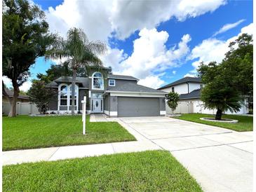 Two-story house with palm trees and driveway at 14534 Potanow Trl, Orlando, FL 32837
