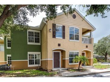 Two-story condo building with green and tan exterior at 4316 S Kirkman Rd # 1602, Orlando, FL 32811