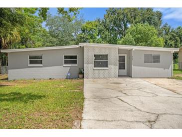 Newly painted house with a well-maintained lawn at 3133 Bon Air Dr, Orlando, FL 32818