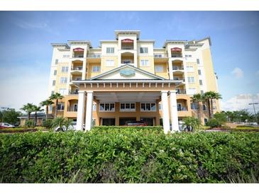 Resort-style building exterior with lush landscaping at 8125 Resort Village Dr # 3514, Orlando, FL 32821