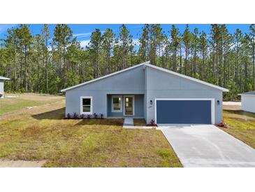 New construction home with gray exterior and blue garage door at 7883 Sw 138Th Street Rd, Ocala, FL 34473