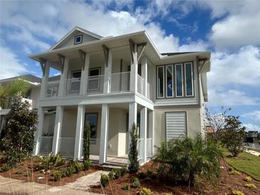 Charming two-story home with a balcony, landscaped yard, and inviting curb appeal at 9982 Fiddley Aly, Orlando, FL 32827