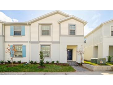 Two-story house with light-colored siding and blue shutters at 8930 Sydney Ave, Kissimmee, FL 34747