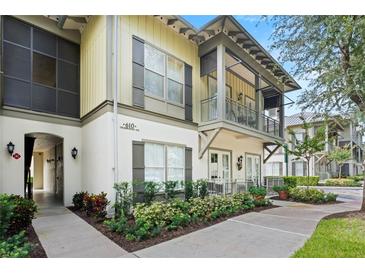 Exterior view of a two-story townhome with a walkway and landscaping at 610 Celebration Ave # 1209, Celebration, FL 34747