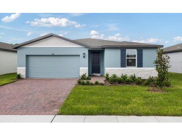 Charming one-story house with blue siding and brick driveway at 3182 Viceroy Ct, Poinciana, FL 34759