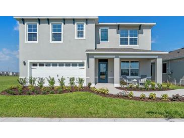 Two-story home exterior with landscaping and porch at 3766 Bluethread Way, Poinciana, FL 34759