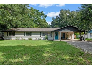 Charming ranch home with a covered carport and a neatly landscaped lawn at 2350 Pleasant Dr, Longwood, FL 32779