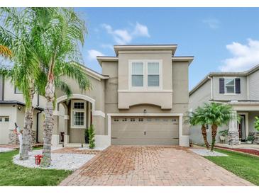 Two-story house with a brick driveway and landscaping at 2599 Nouveau Way, Kissimmee, FL 34741