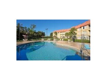 Inviting community pool with ample deck space for lounging at 6336 Parc Corniche Dr # 3303, Orlando, FL 32821