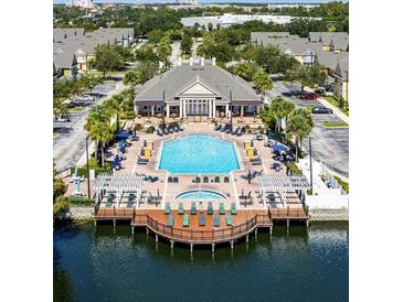 Inviting community pool with a spa, lounge chairs, and a clubhouse at 2601 Gala S Rd # 107, Kissimmee, FL 34746