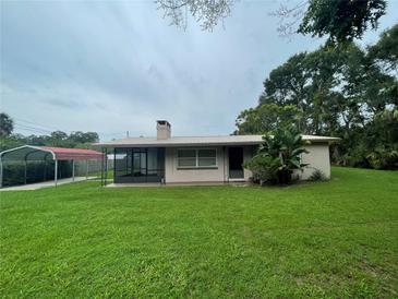 Ranch style home with carport and screened porch at 2815 N Leavitt Ave, Orange City, FL 32763