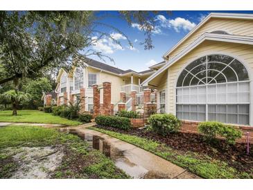 Two-story condo building with brick accents and lush landscaping at 5009 Laguna Bay Cir # 41, Kissimmee, FL 34746