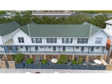 Aerial view of a townhome community showcasing multiple units with green roofs and private patios at 720 Celebration Ave # 220, Celebration, FL 34747