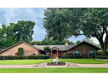 Brick ranch house with mature landscaping at 3336 Edgecliffe Dr, Orlando, FL 32806