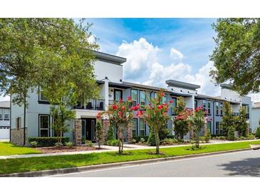 Modern townhouses with attractive landscaping and balconies at 2120 Broome St, Kissimmee, FL 34743