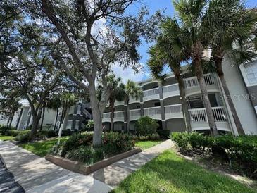 Exterior view of a two-story apartment building with landscaping and walkways at 13953 Fairway Island Dr # 624, Orlando, FL 32837