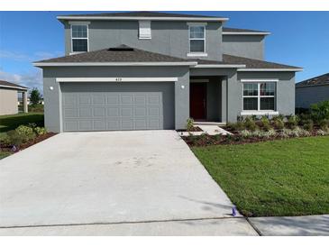 Two story house with attached garage and landscaping at 420 Quarry Rock Cir, Kissimmee, FL 34758