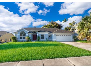 Single story home with a two car garage and large front yard at 7304 High Lake Dr, Orlando, FL 32818