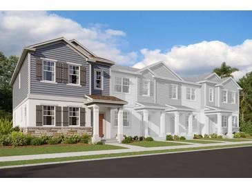 Modern 2-story townhome with gray siding and stone accents at 15859 Tollington Aly, Winter Garden, FL 34787