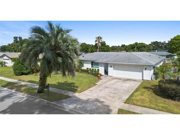 Single story home with white exterior and a two-car garage at 115 Marcy Blvd, Longwood, FL 32750