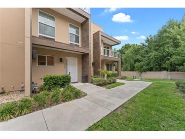 Modern townhome exterior with a landscaped walkway at 3175 Brasilia Ave, Kissimmee, FL 34747