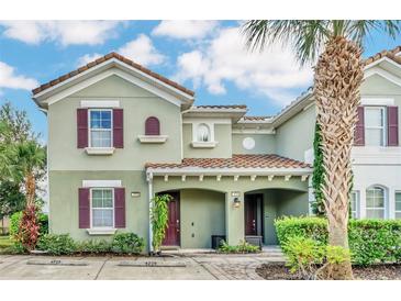 Charming two-story house with maroon shutters at 4738 Terrasonesta Dr, Davenport, FL 33837