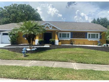 Charming yellow house with a well-maintained lawn at 8272 Le Mesa St, Orlando, FL 32827