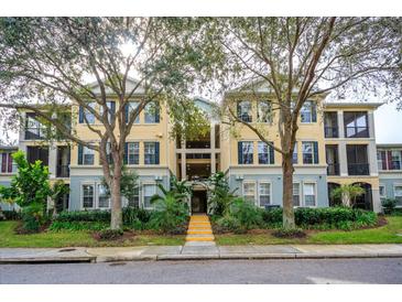 Three-story building exterior with landscaping and parking at 11434 Jasper Kay Ter # 306, Windermere, FL 34786