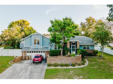 Two-story house with a large yard and driveway at 3500 Sail Fish Ave, Fruitland Park, FL 34731