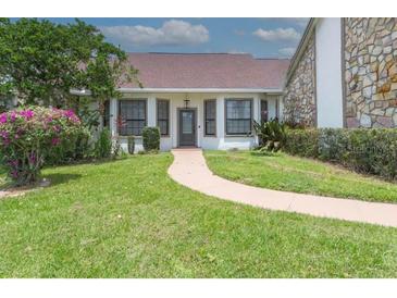 Inviting home exterior with walkway and landscaping at 2228 Sylvan Ct, Kissimmee, FL 34746