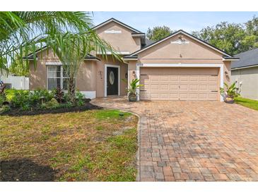 Two-story house with a brick driveway and landscaping at 4732 Park Eden Cir, Orlando, FL 32810