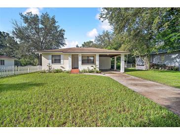 Charming bungalow with a carport, well-maintained lawn, and white picket fence at 507 Francis Blvd, Lakeland, FL 33801