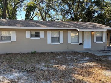 Tan single story house with white trim and a small front yard at 5146 Liming Ave, Orlando, FL 32808