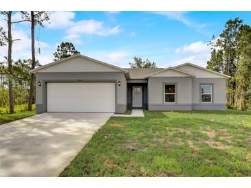 Single-story home with gray exterior and white garage door at 1308 Hillsborough Ct, Kissimmee, FL 34759