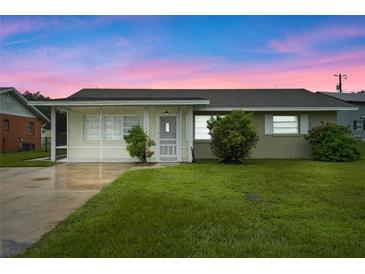 Charming ranch-style home with a well-manicured lawn at 106 Oregon Ave, Saint Cloud, FL 34769